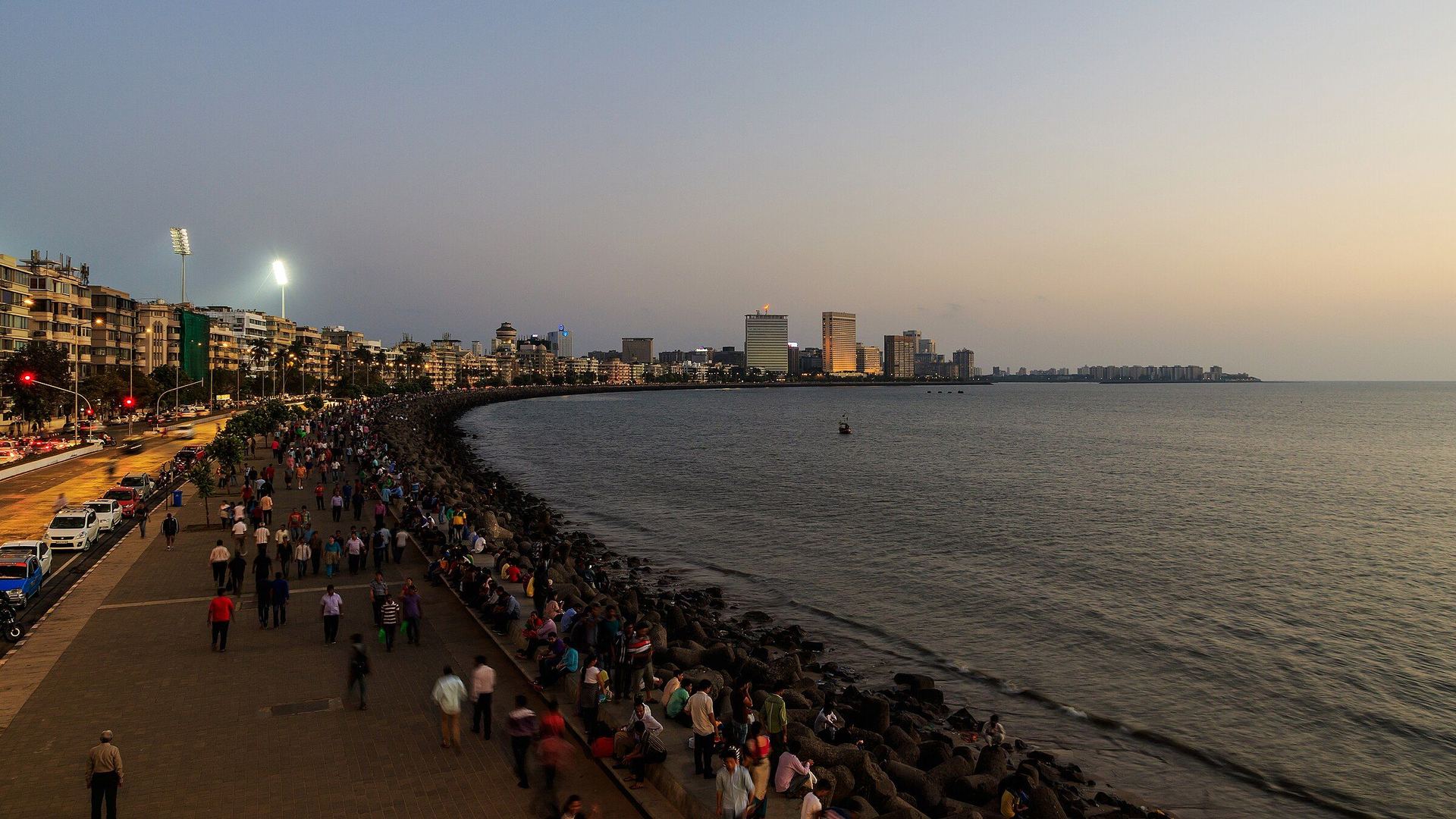 Marine Drive in Mumbai at dusk, the bay curving towards the skyline.