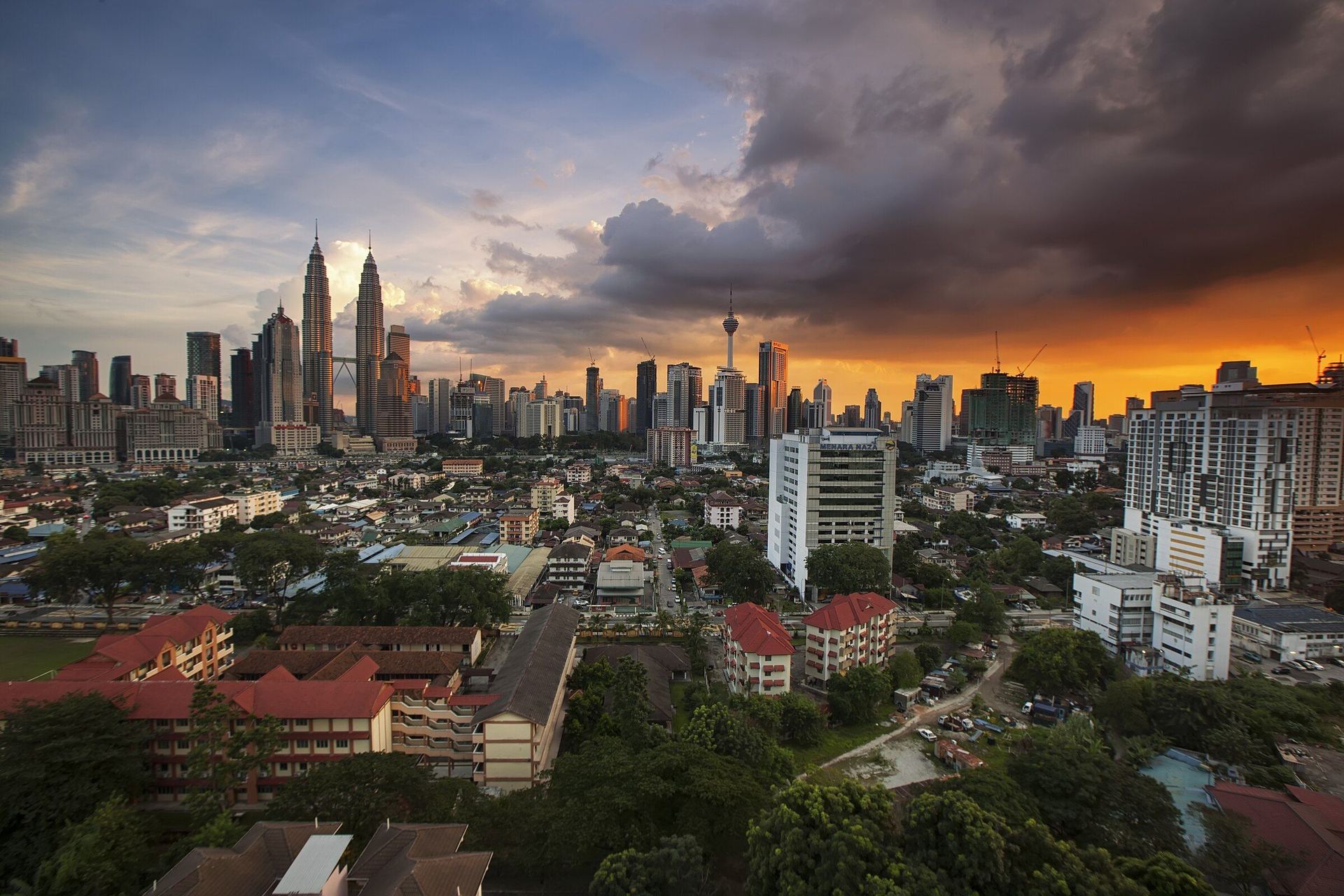The Kuala Lumpur skyline at dusk, with the Petronas Towers and KL Tower.